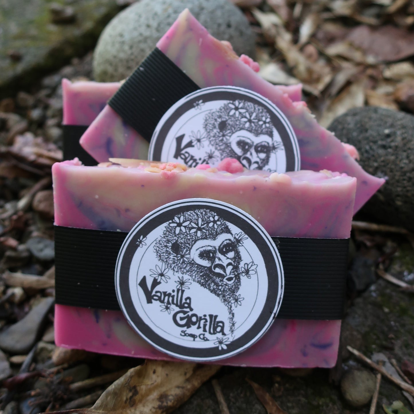 Two pink/lavender soap bars with a vanilla gorilla logo on a natural background