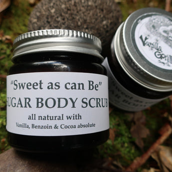 Jar of 'Sweet as can be' sugar body scrub with a label on a natural background