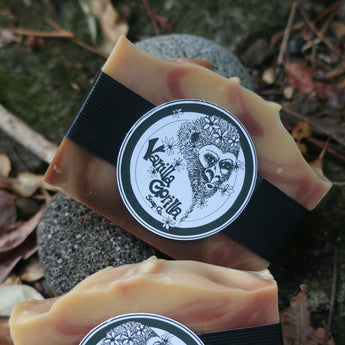 Two fizzy grapefruit bars of soap with black straps and branded labels on a natural background.