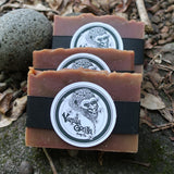 Three bars of soap with a vanilla gorilla brand logo on a natural background