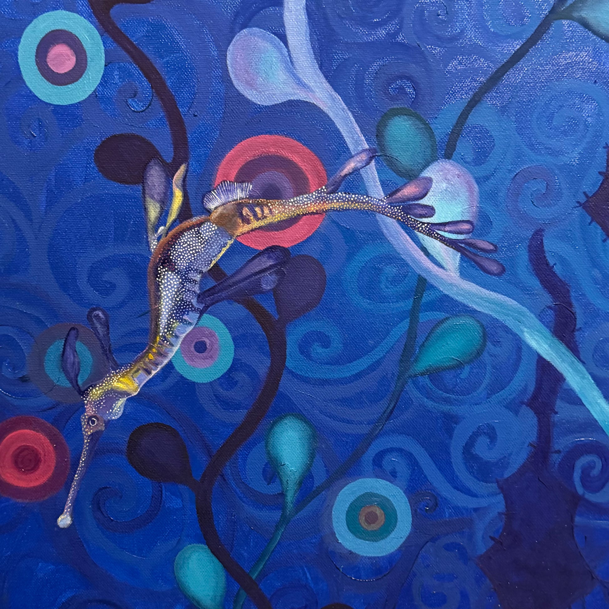 Colorful artwork of a sea dragon among swirling patterns on a blue background