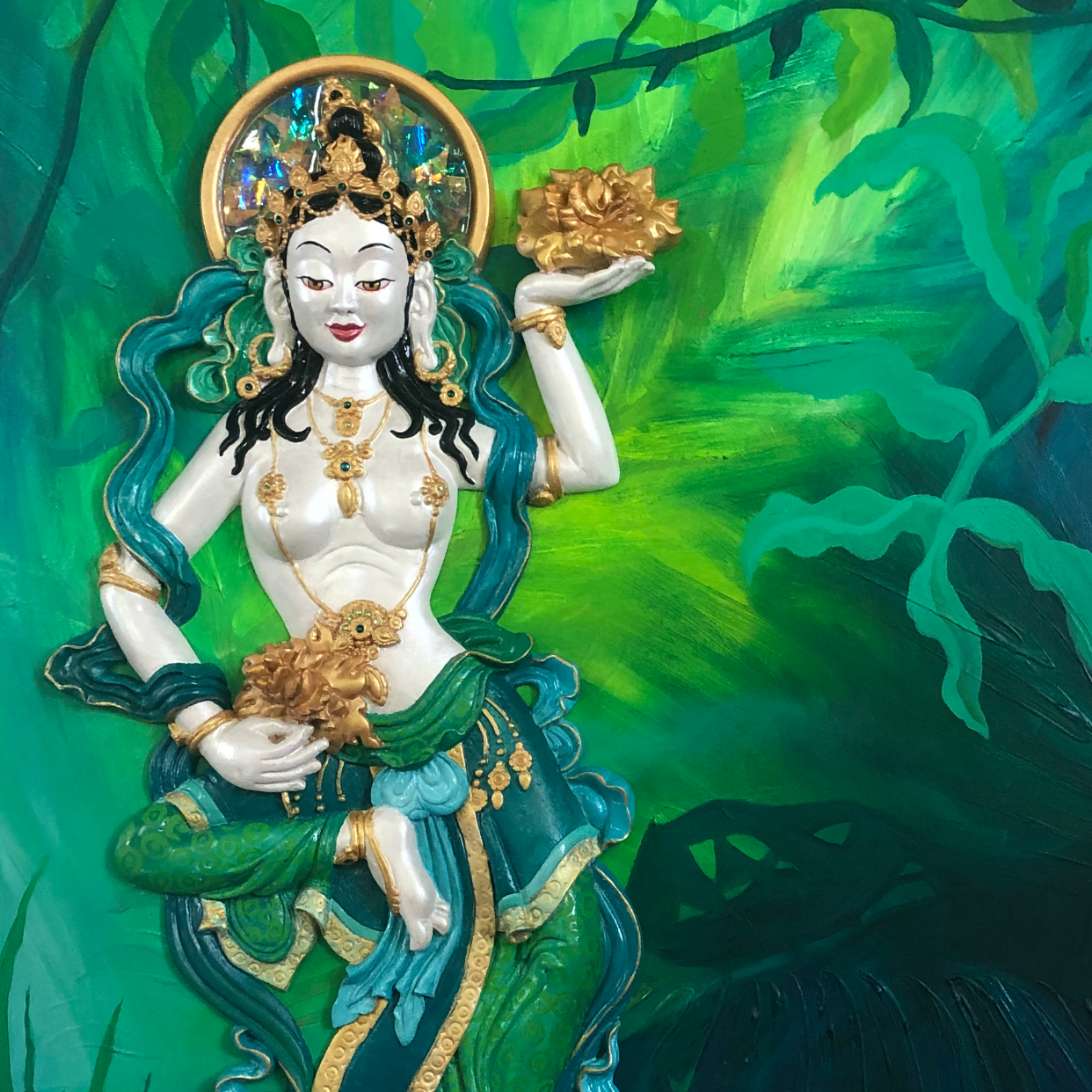 white  sculpted offering goddess on a 2d oil painting of green jusgle