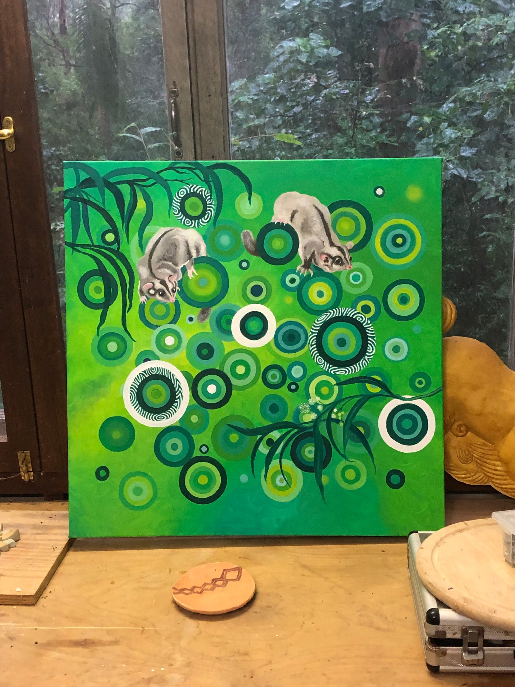 An oil on canvas painting featuring two Australian Native Sugar Gliders in a green and white color palette, with abstract green circles around them.