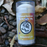 The OG Deodorant stick with a vanilla gorilla label on a natural background of leaves and stones