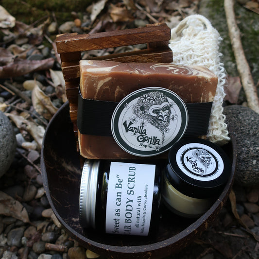 Bar of soap and jar of sugar scrub on a textured surface with natural elements