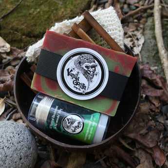 Bar of sweet candy apple soap and in the woods deodorant with a vanilla gorilla logo on a natural background