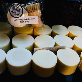 Multiple bars of soap with a lemon myrtle and coconut dish soap bar in the background.