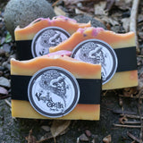 Three bars of rosey citrus soap with 'Vanilla Gorilla Soap Co.' labels on a natural background.