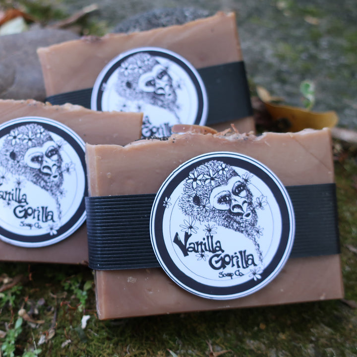 3 oatmeal milk & honey soap bars with vanilla gorilla labels in a mossy natural setting