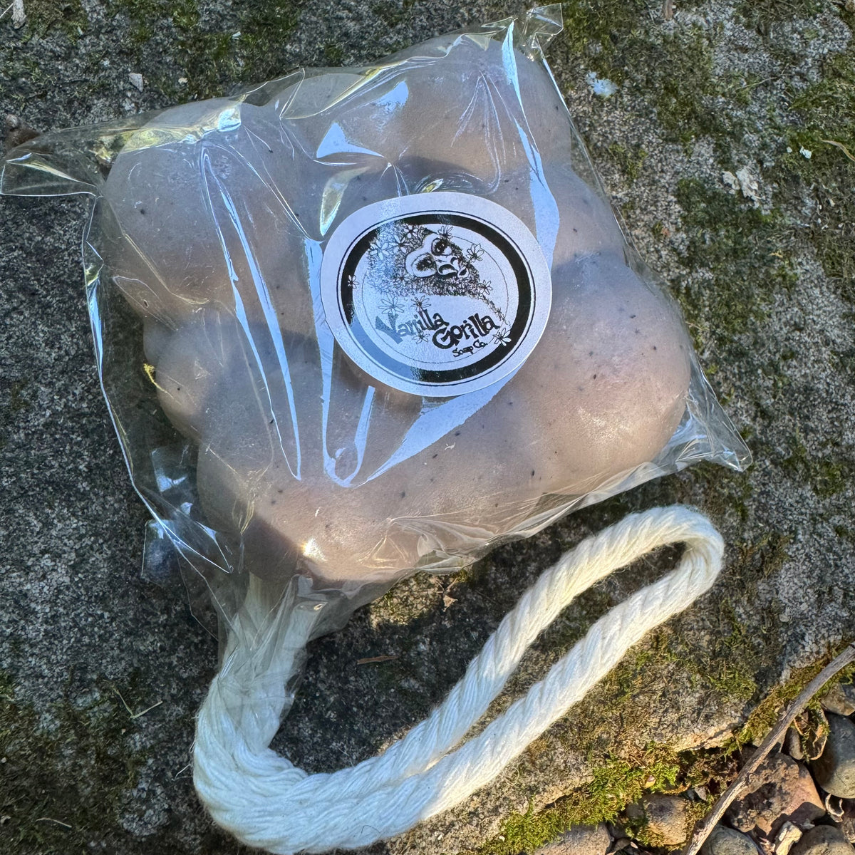 Cloud shaped soap with a rope and 'Vanilla Gorilla' label on a stone surface