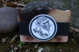 Bar of raspberry ice soap with 'Vanilla Gorilla Soap Co.' label on a natural background