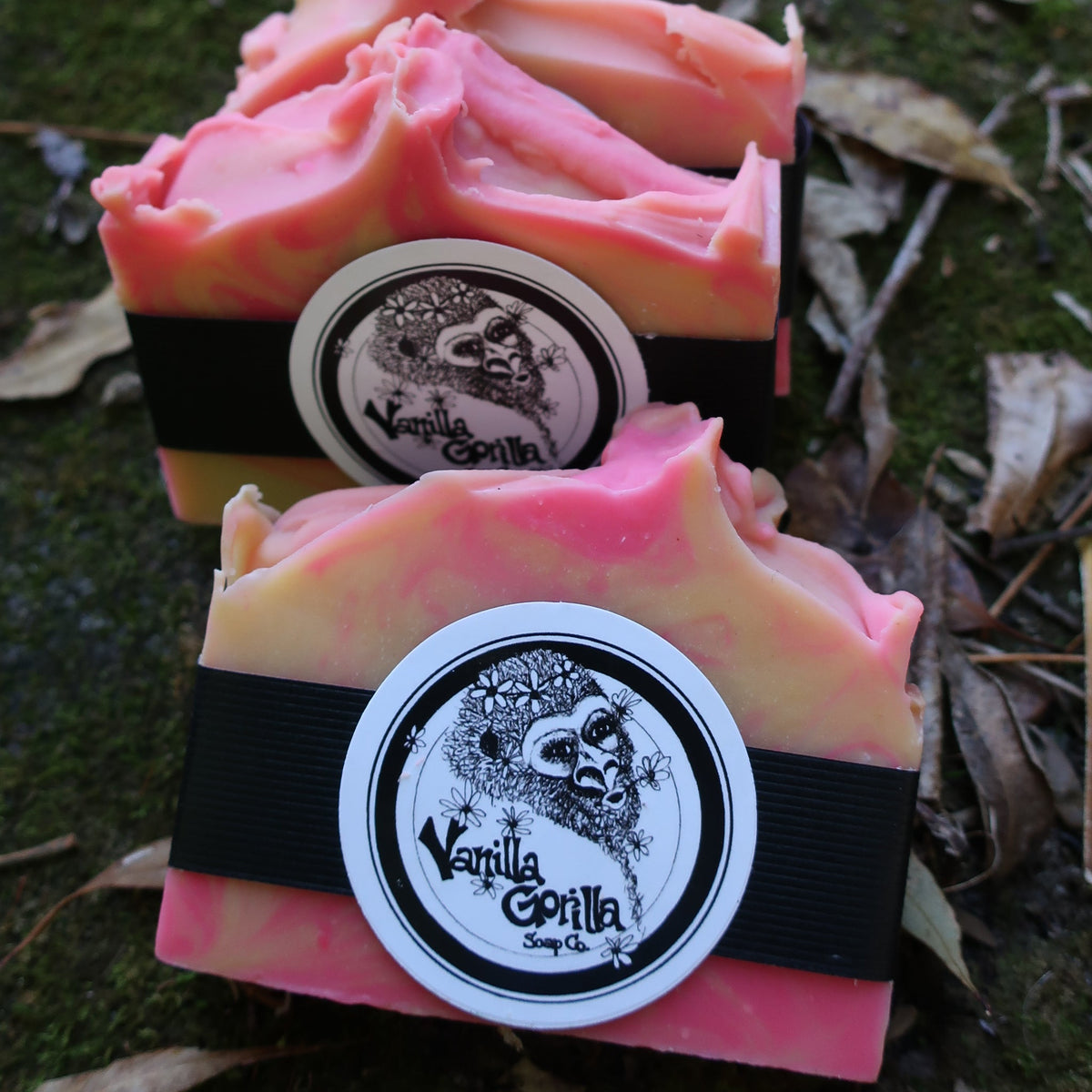 Two pink rosey citrus soap bars with vanilla gorilla logo on a natural background