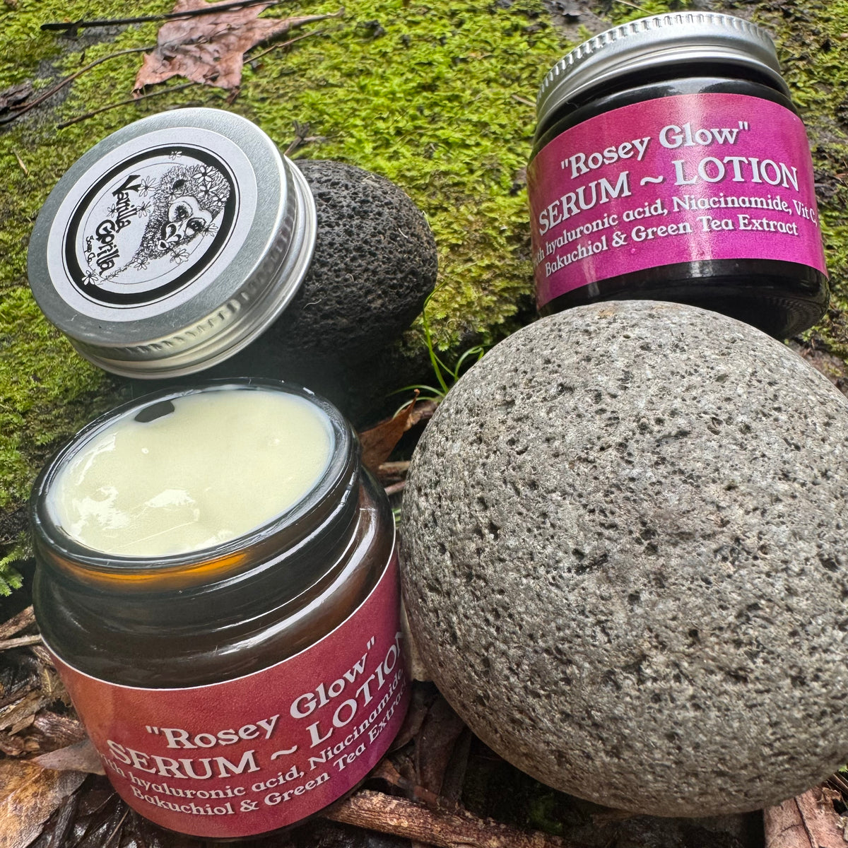 Three 'Rosey Glow' skincare products on a natural background with a stone.
