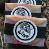 Three colorful love spell soap bars with a vanilla gorilla logo on a natural background